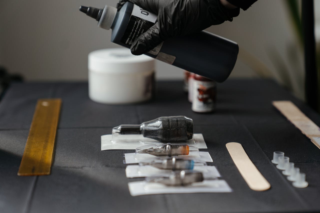 Close-up of tattoo equipment and ink in a tattoo studio, showcasing tools and preparation.